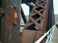 Looking down the south edge of the bridge at the west end. Note the damage on the diagonal bent in the foreground.
