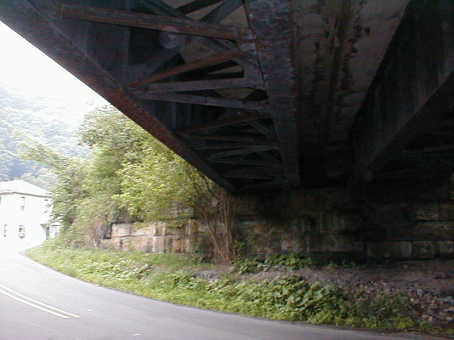 View of underside of railroad bridge just east of Colliers. View looks toward railroad west end of bridge; Road west is to the left. (40.36716N 80.52554W)